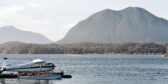 Float plane on water in front of steep hills