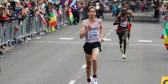 Cam Levins runs toward the finish line in fine form while his competitors trail behind him.